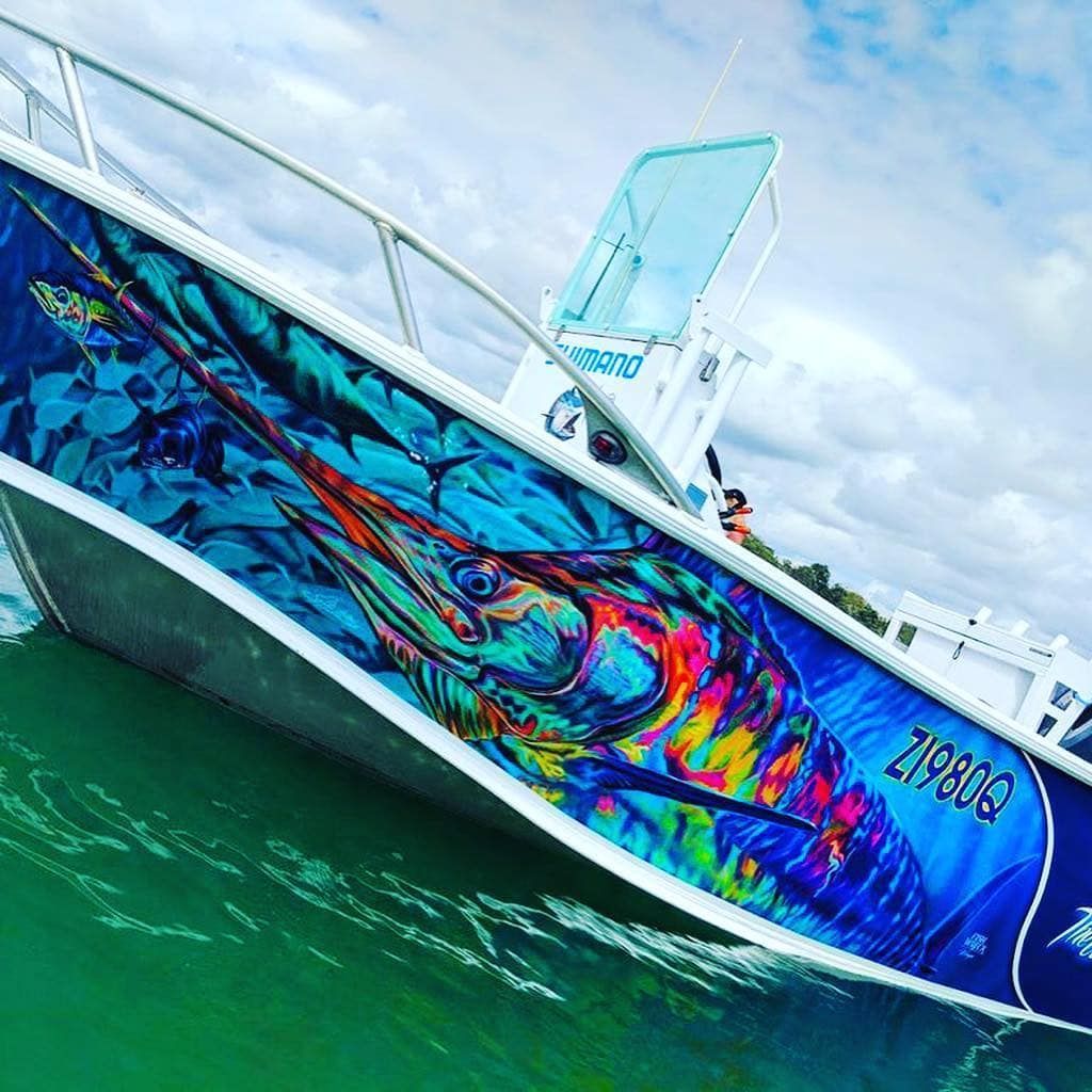A Boat with A Painting of A Marlin on The Side Is in The Water — DNA Signs in Tweed Heads, NSW
