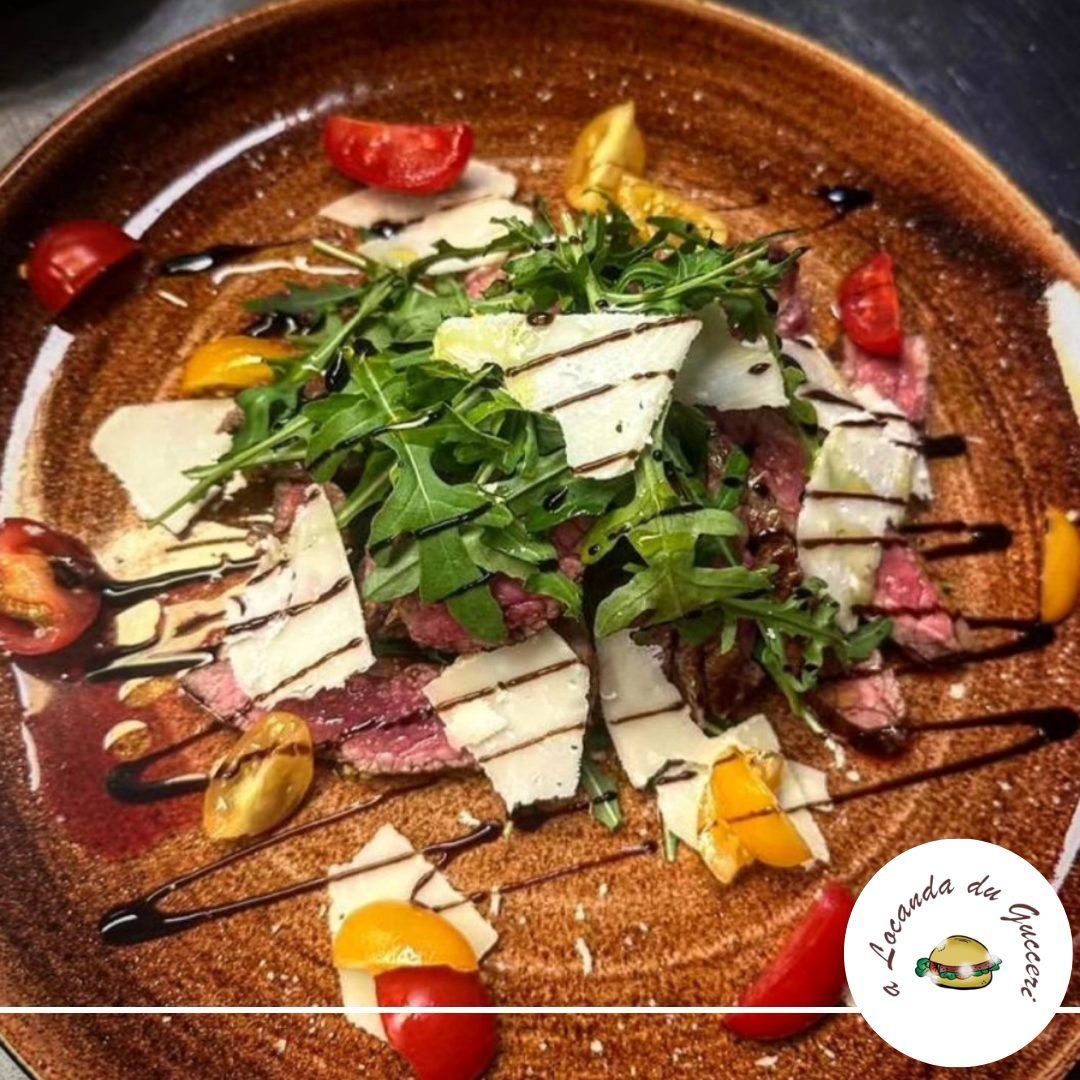 tagliata di vitello con pomodorini, scaglie di grana, rucola fresca e aceto balsamico