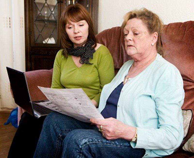 Two Women Reading Together — Lexington, KY — Kentucky Guardianship Association