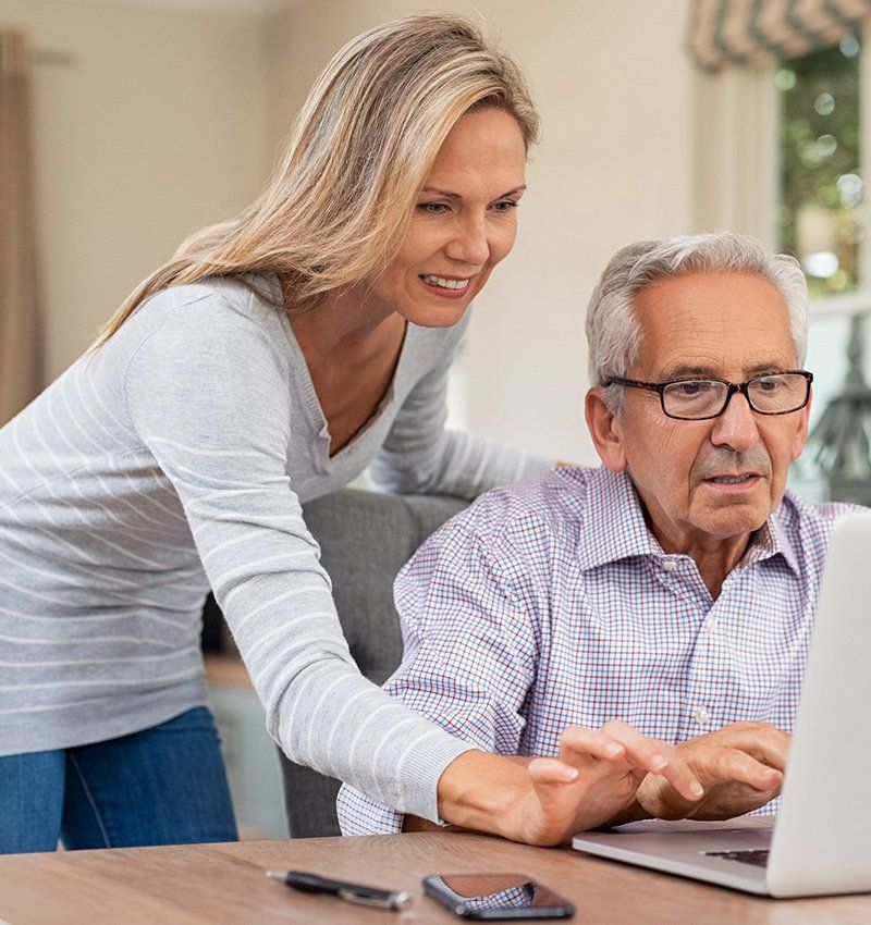 Woman Assisting Elderly Man on Laptop — Lexington, KY — Kentucky Guardianship Association