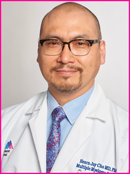 A bald man wearing glasses and a white lab coat