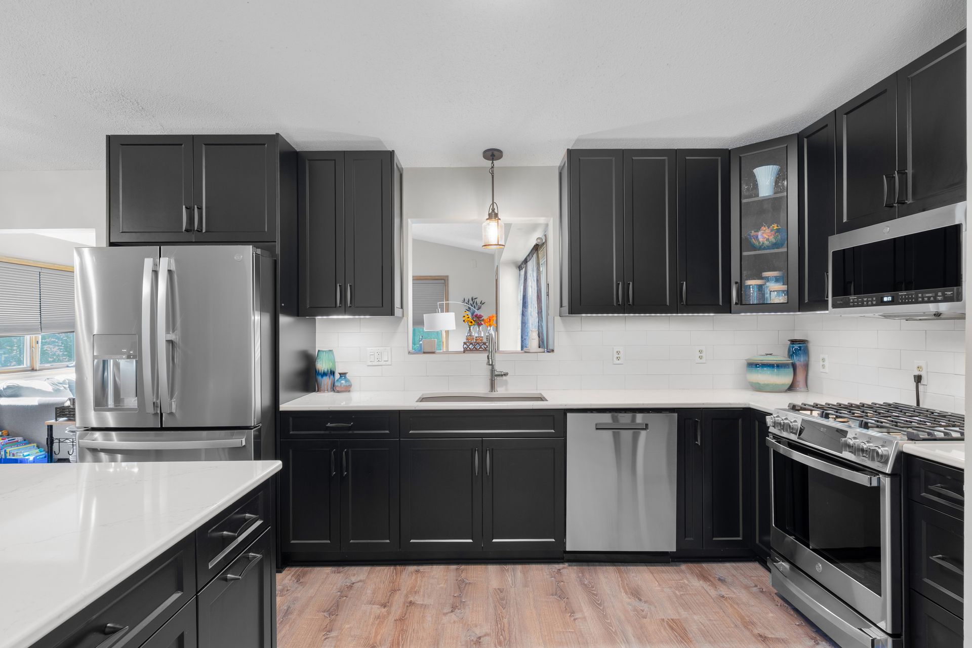 Painted custom kitchen cabinets from the Twin River Cabinets Casa Collection with contrasting island and custom color finish.