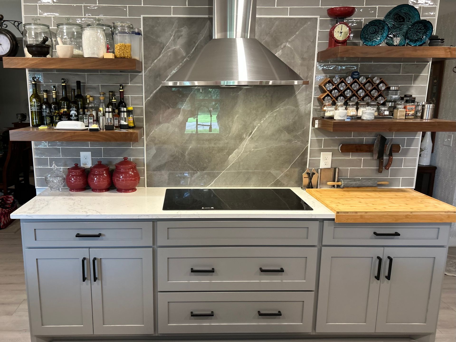 A kitchen with a stove top oven and a hood. A kitchen with a stove top oven and a hood.