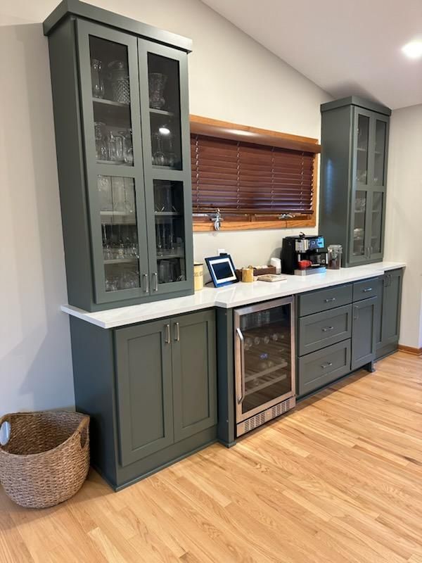A kitchen with gray cabinets