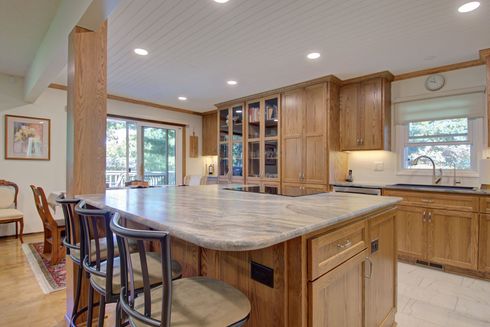Natural wood Signature Collection cabinetry by Twin River Cabinets featuring warm wood tones and a custom kitchen design.