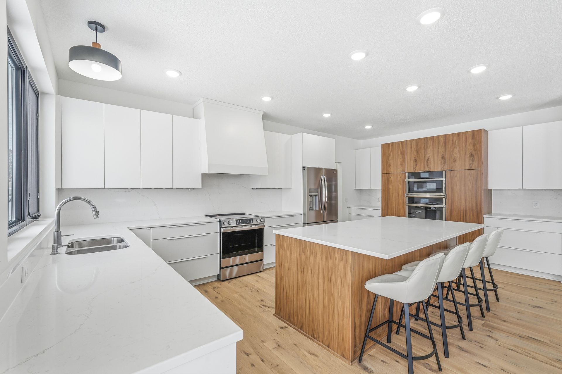 White Signature Collection kitchen with walnut island and walnut accent cabinetry in Centerville, Minnesota.