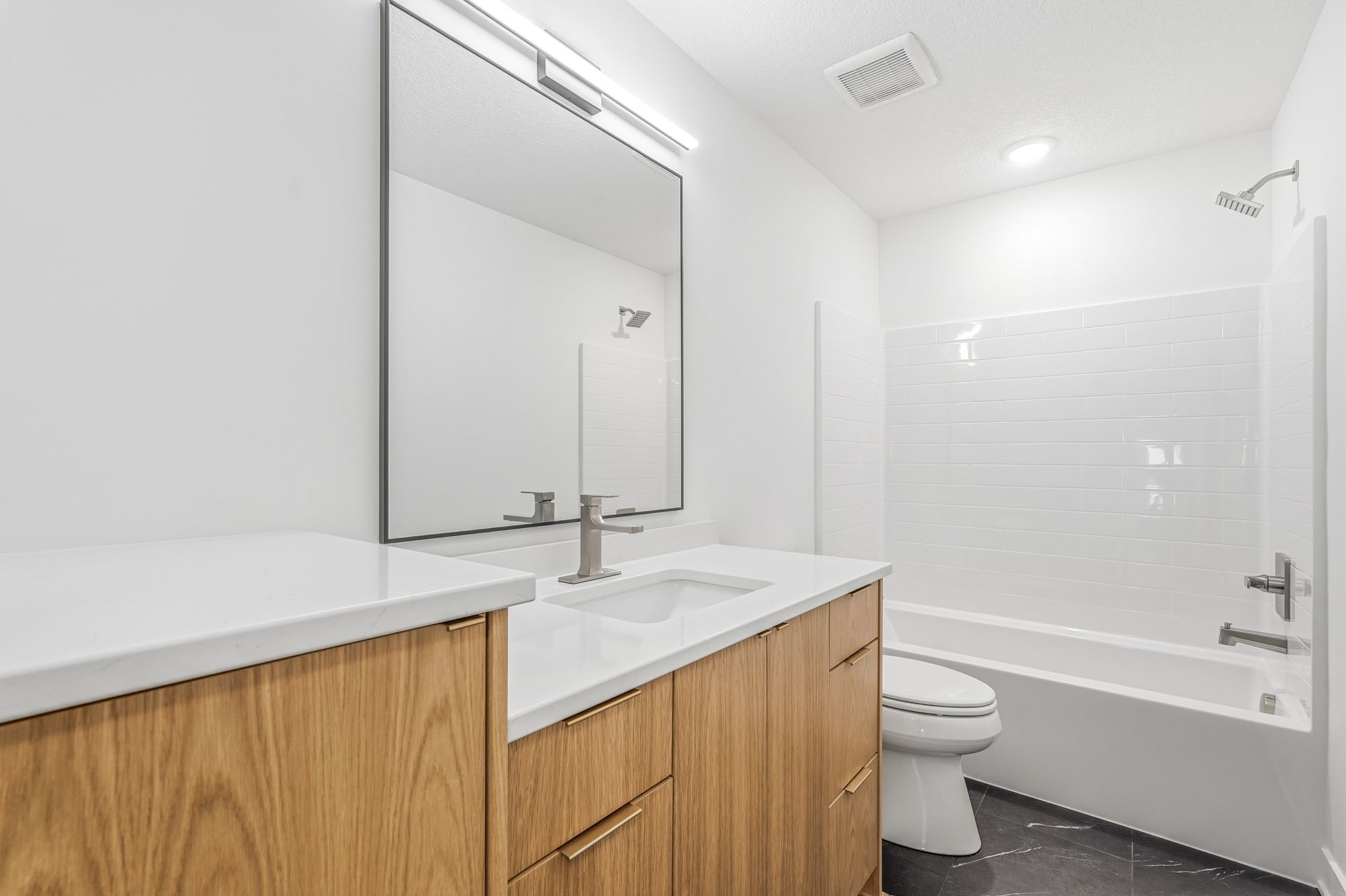 White Oak Luxe Collection bathroom vanity with white countertop and clean modern design in Centerville, Minnesota.