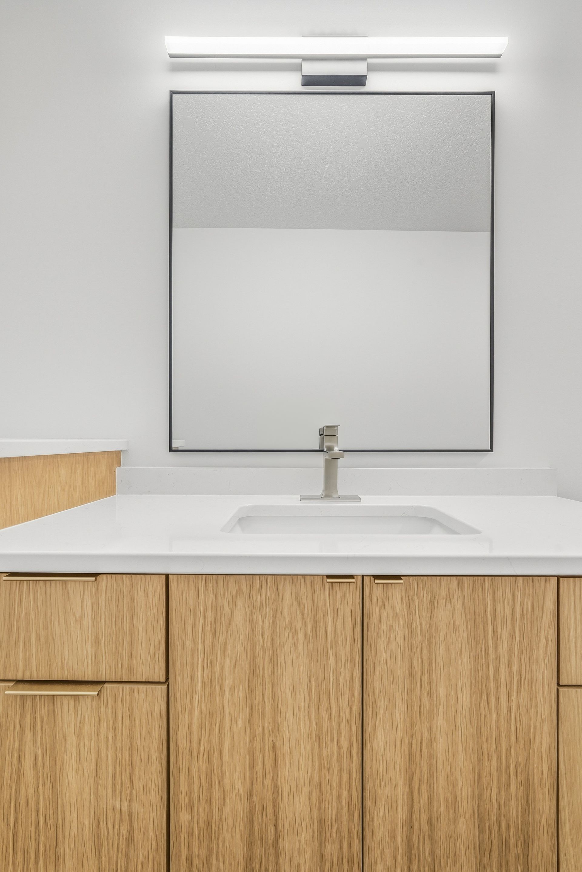 Custom white oak bathroom vanity with flat-panel cabinetry in Centerville, MN