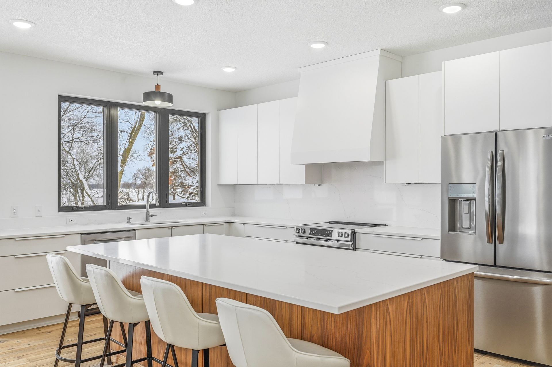 White Signature Collection kitchen with walnut appliance cabinetry and contrasting walnut island in Centerville, Minnesota.