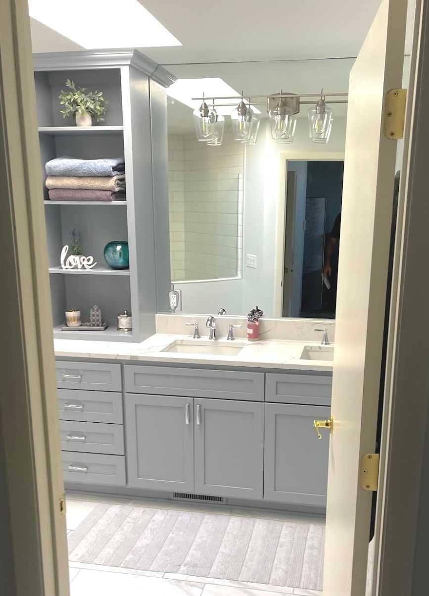 Gray double bathroom vanity with custom cabinetry and open linen storage