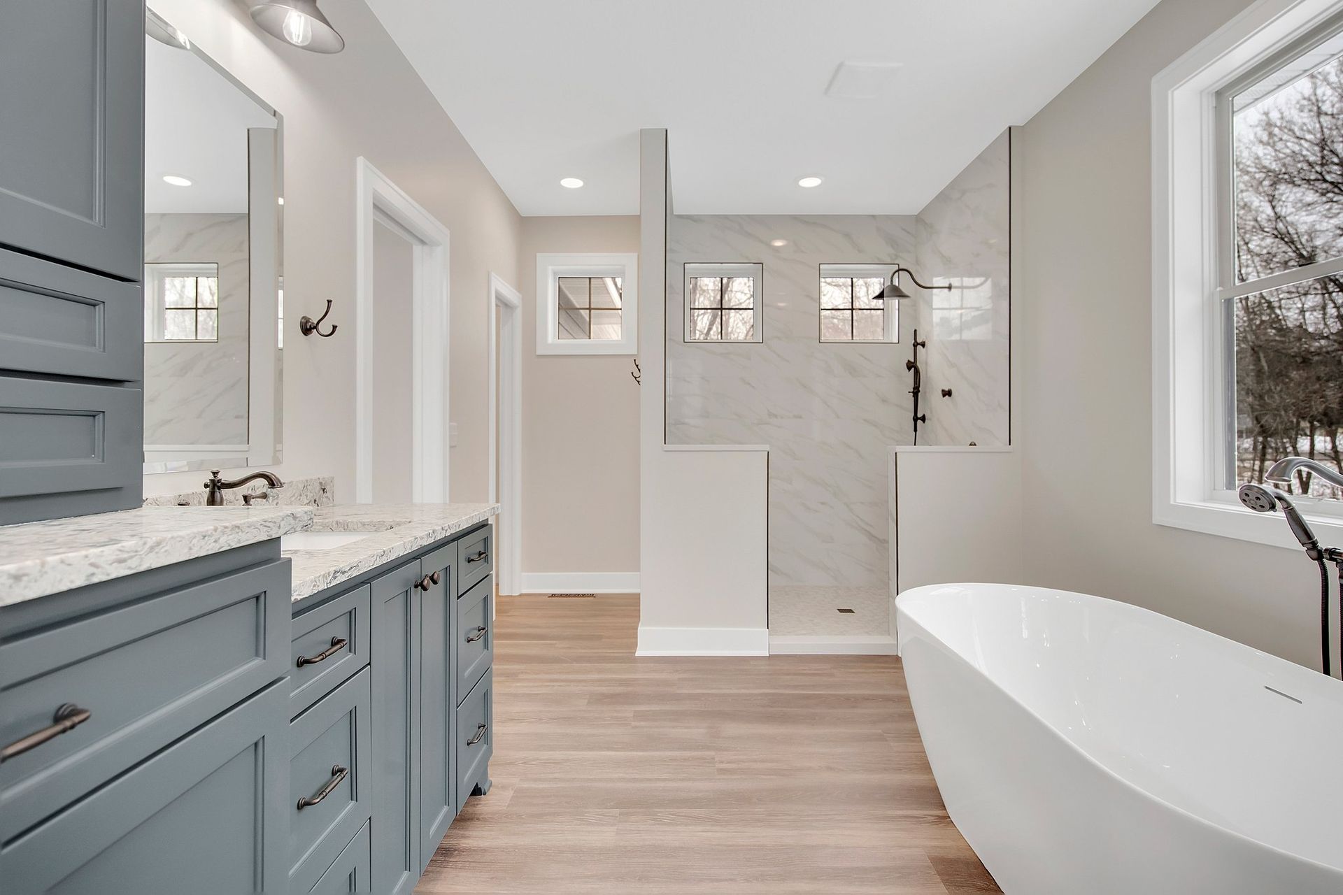 Custom painted bathroom vanity cabinetry with double sinks and drawer storage