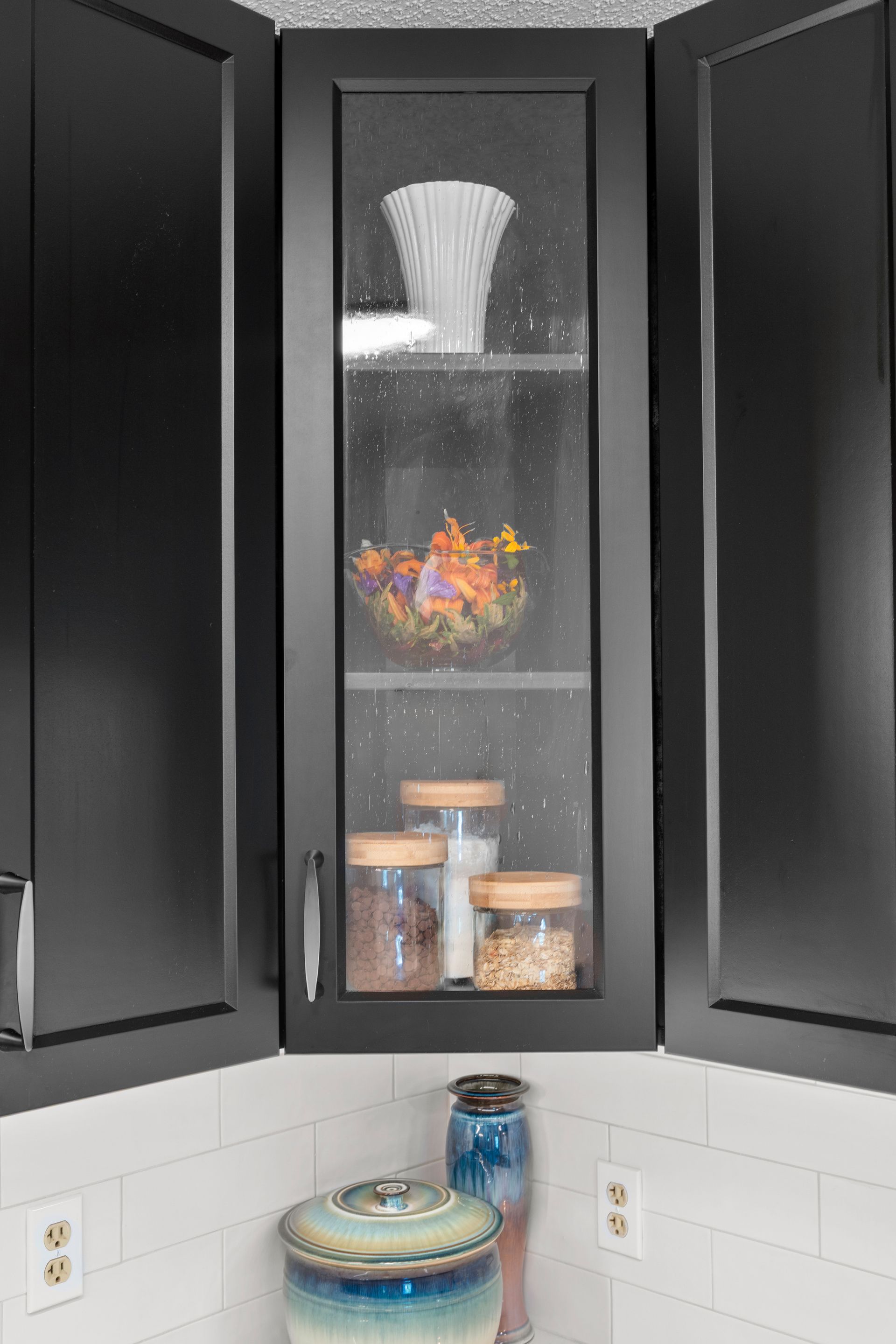 Black Casa Collection corner cabinet with glass-front display storage in Lino Lakes, Minnesota.