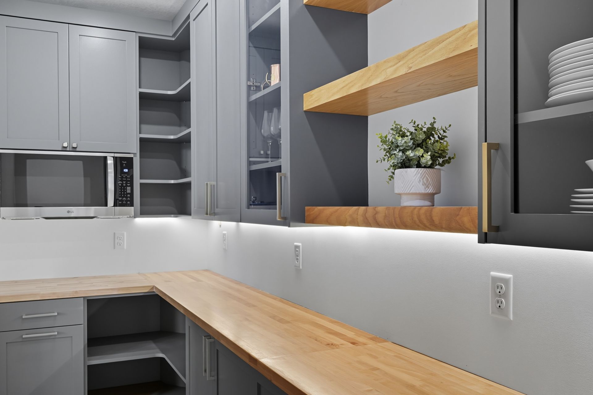 Custom pantry cabinetry in Oak Grove, MN with gray cabinets, wood countertops, and open shelving.