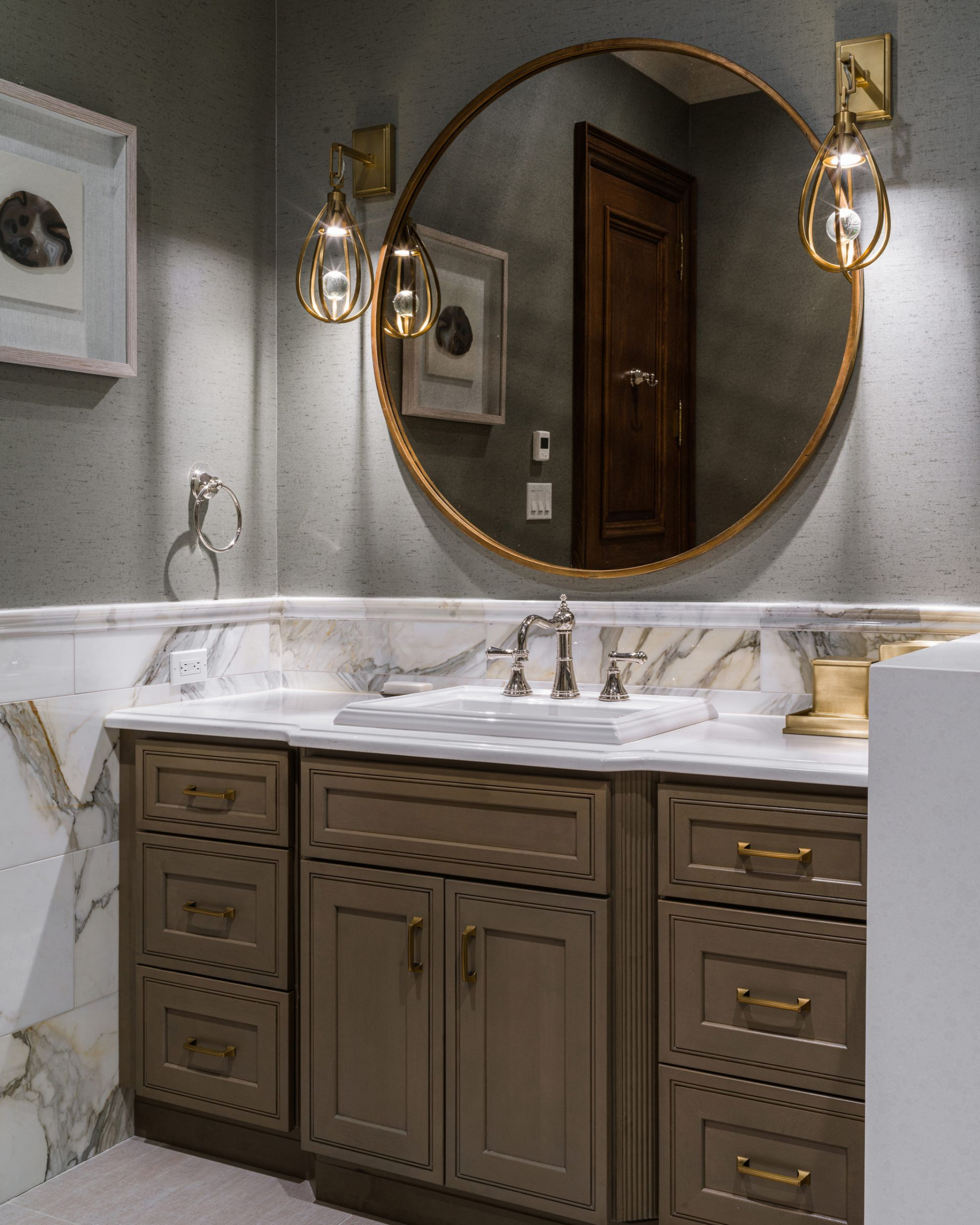 Semi-custom Summit bathroom vanity with warm taupe cabinetry and gold hardware.