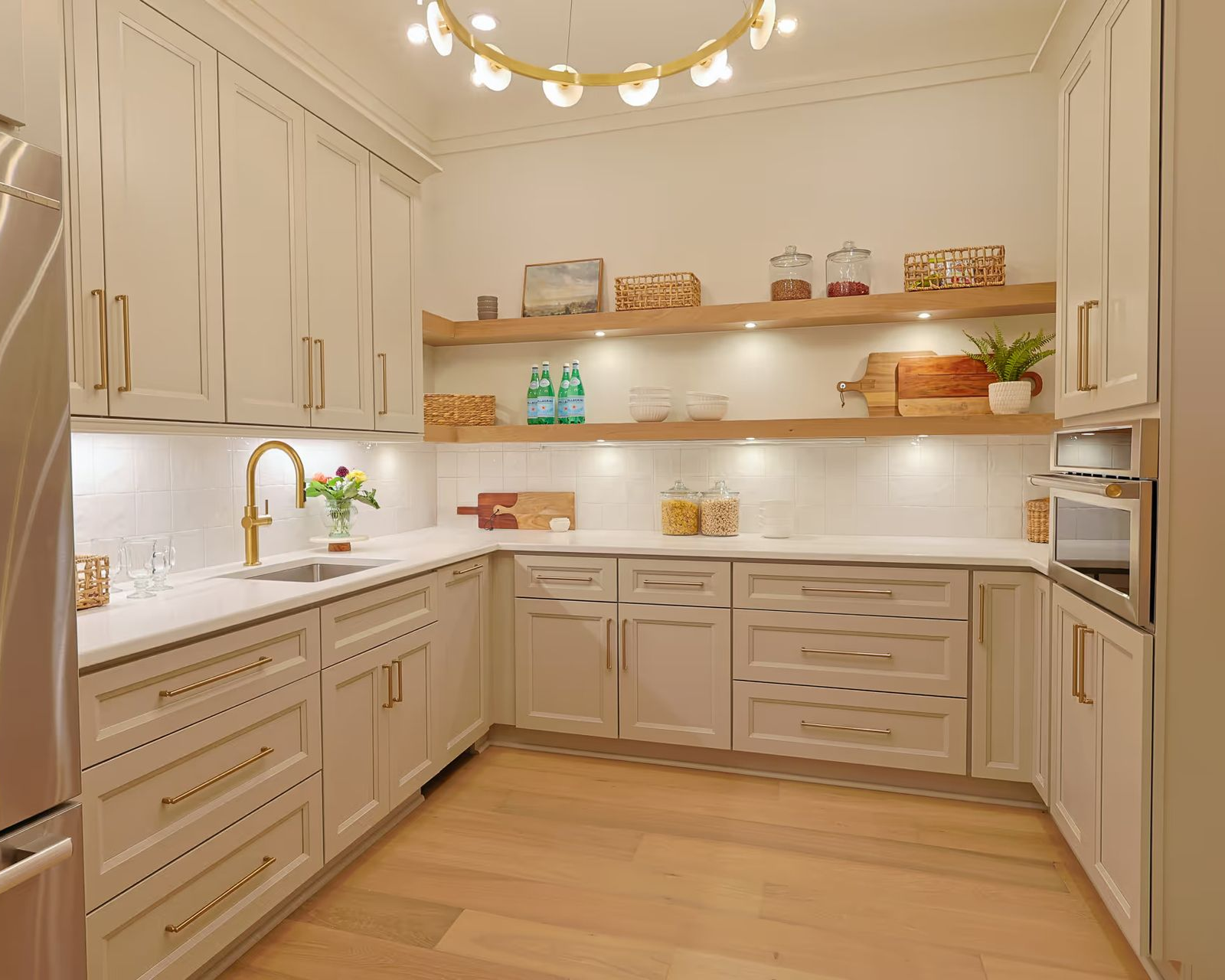 Semi-custom Summit pantry with neutral cabinetry, shaker doors and open shelving.