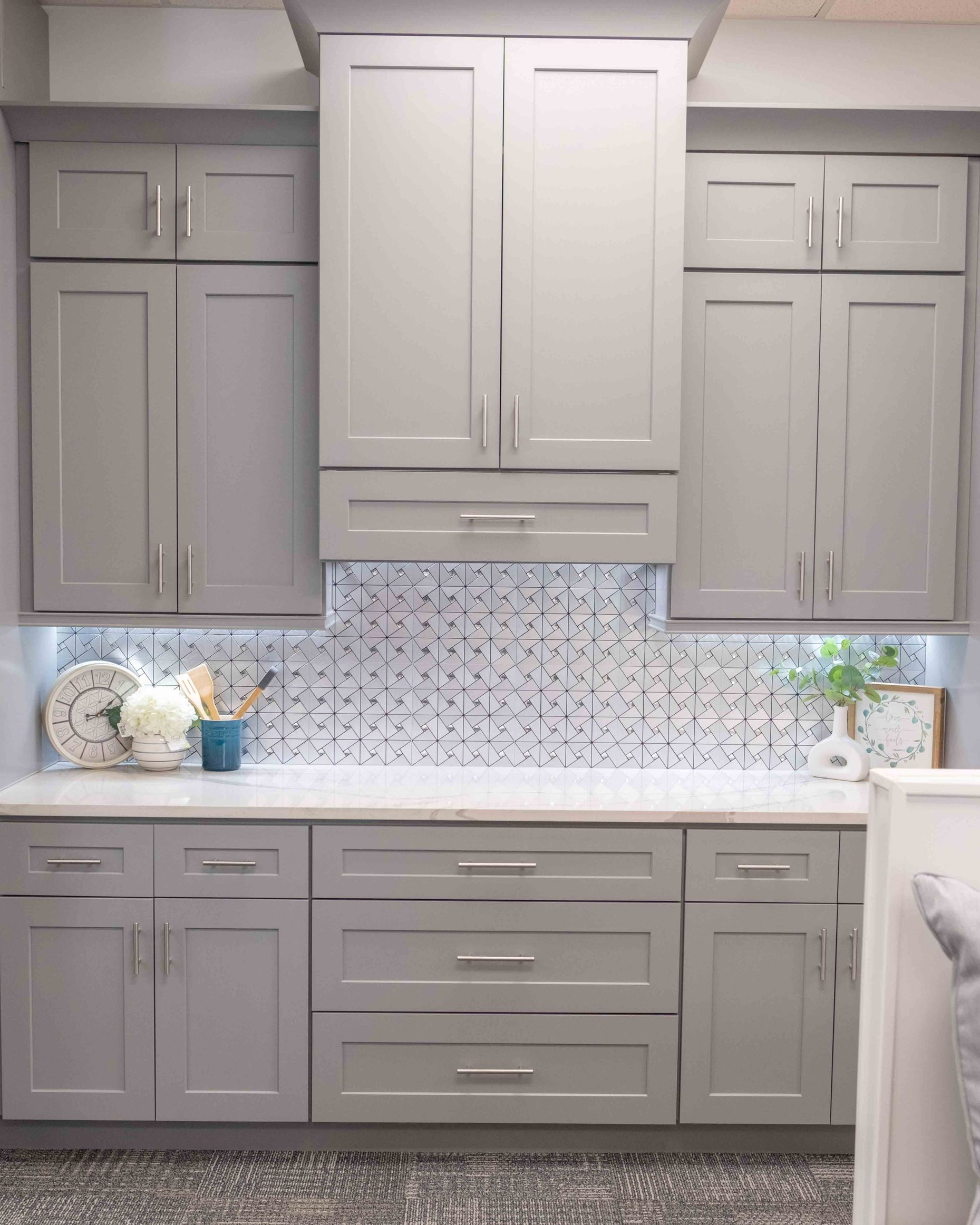 Gray Summit semi-custom built-in cabinetry with shaker doors, drawers and countertop workspace.