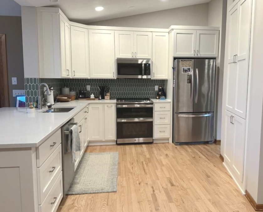 White painted Casa Collection kitchen cabinetry with Shaker-style doors, bright countertops, and clean lines.