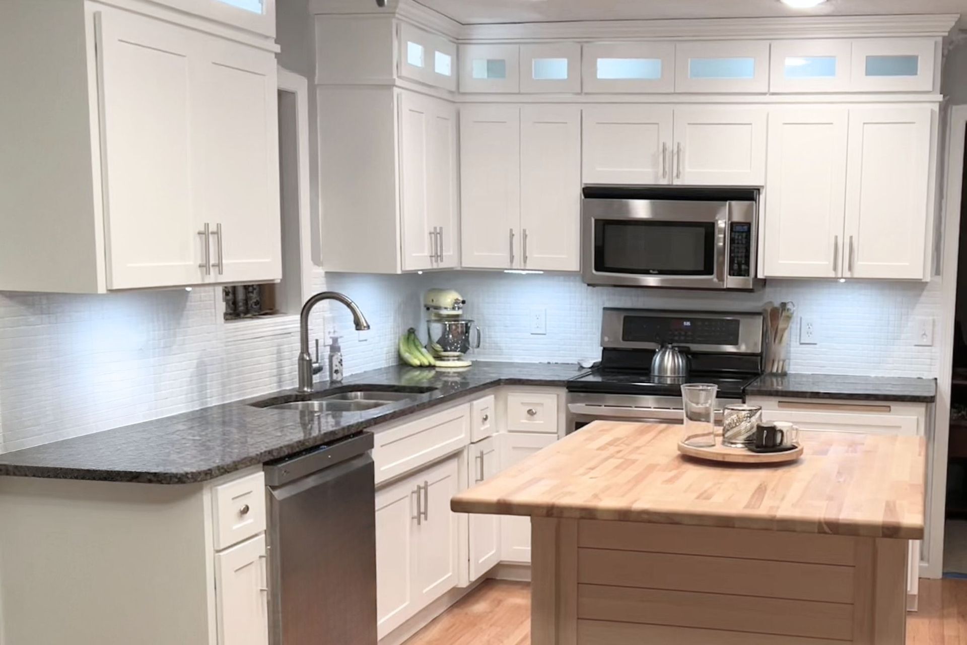 Painted custom kitchen cabinets from the Twin River Cabinets Casa Collection with contrasting island and custom color finish.