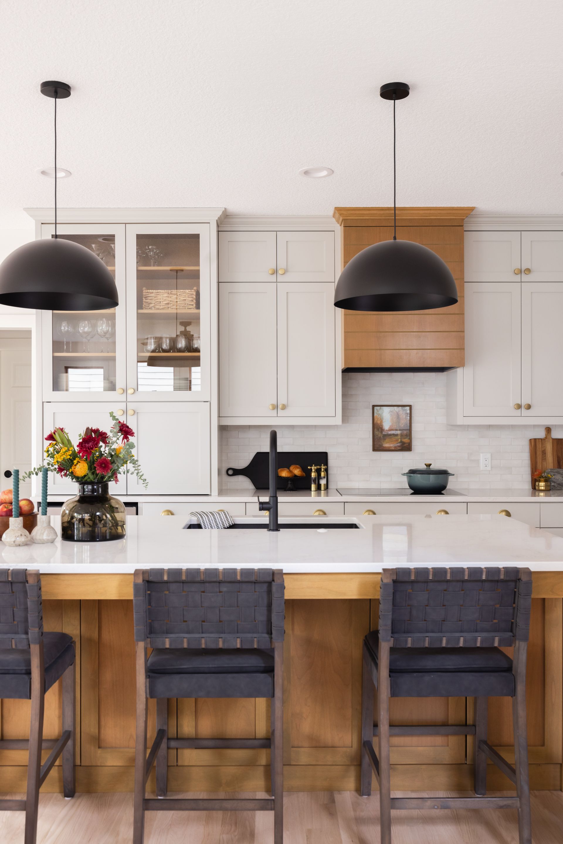 White Signature Collection kitchen with large island, seating, and natural wood accents in Woodbury, Minnesota.