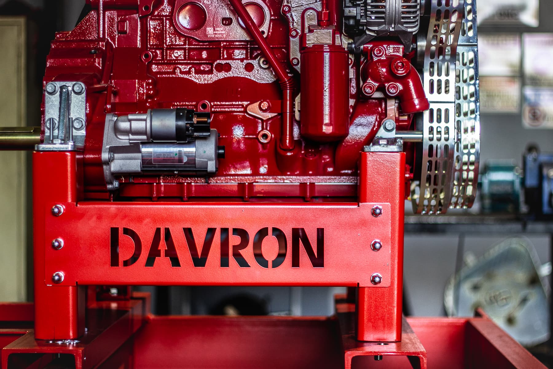 Red industrial machine with “DAVRON” branding in a workshop setting