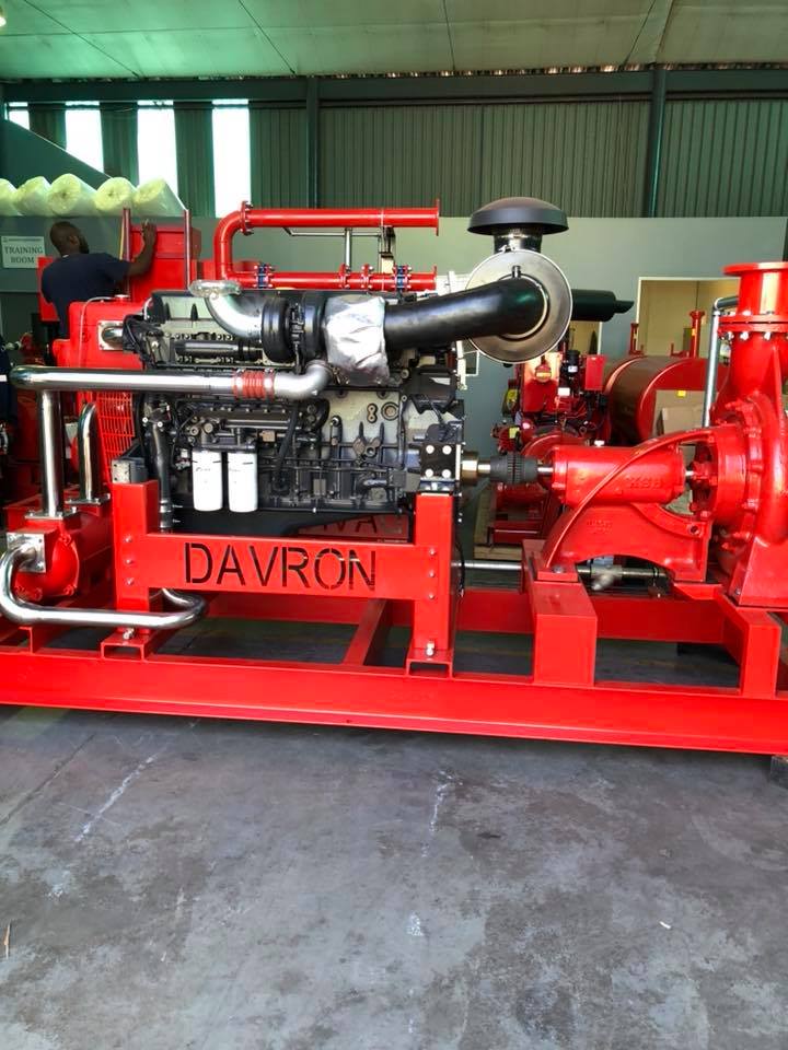 Red industrial engine mounted on a frame in a workshop, labeled DAVRON.