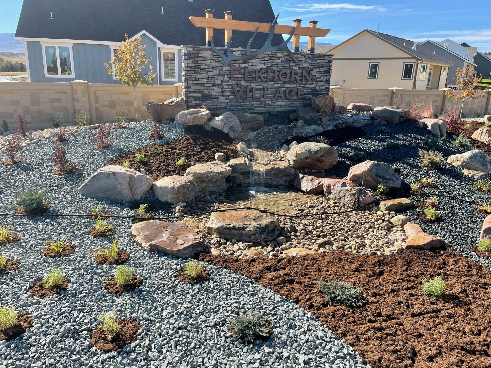 A stone neighborhood entrance sign for 