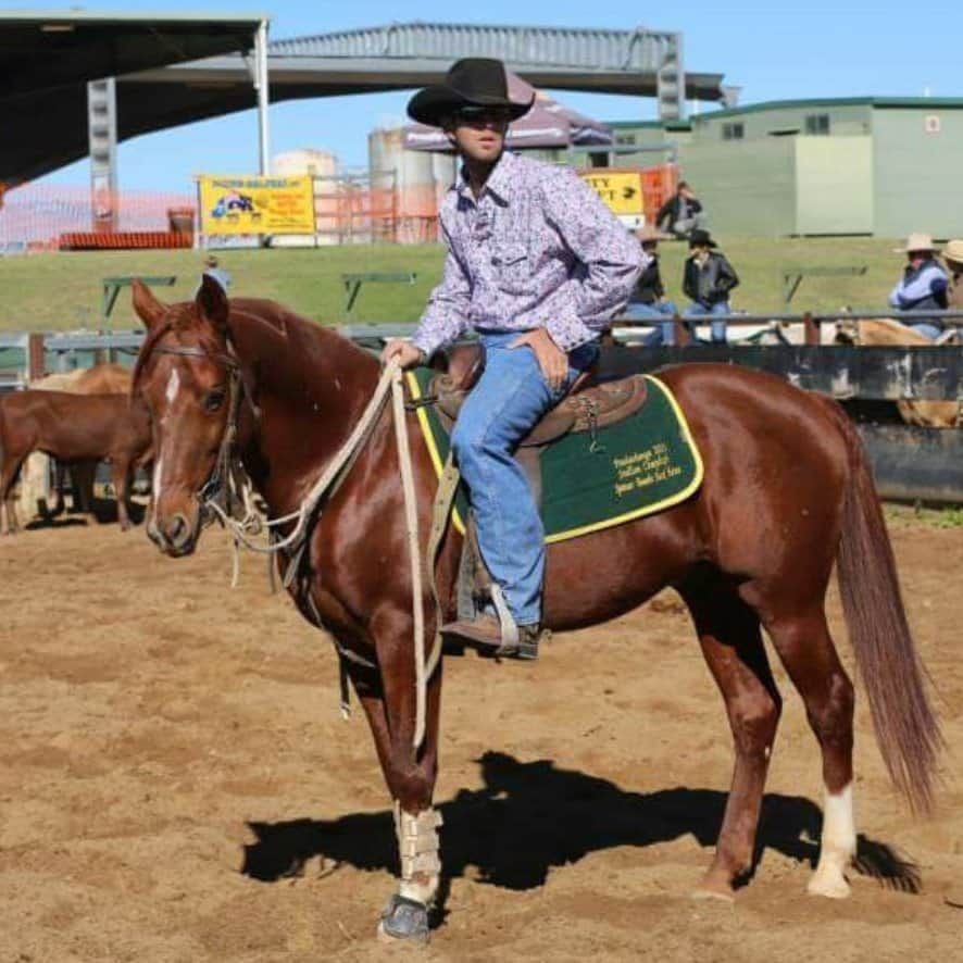 A Man Is Sitting On A Horse— Jono Battle Equine Services In Walkamin, QLD