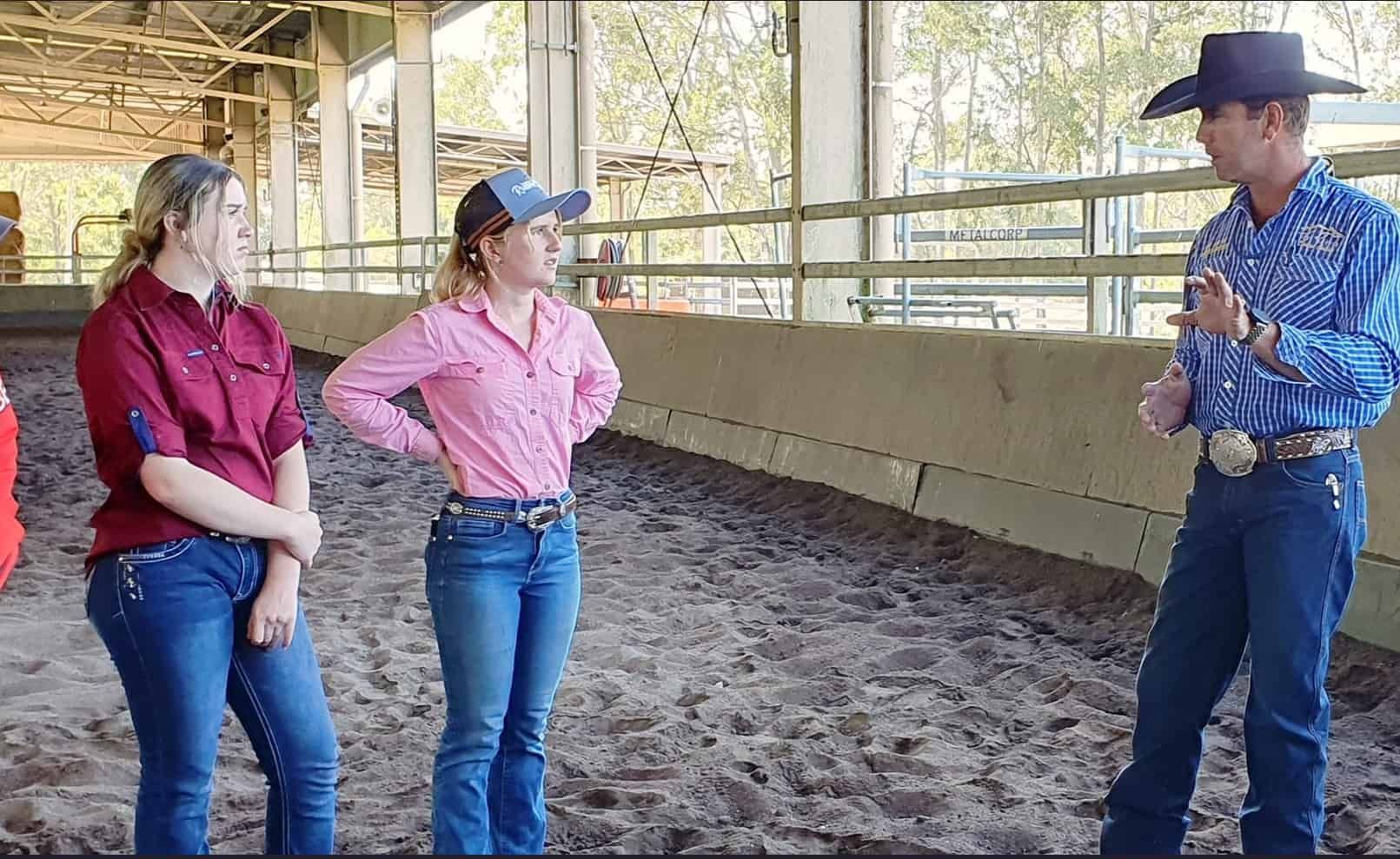 A Man In A Cowboy Hat Is Talking To Two Women In A Stable — Jono Battle Equine Services In Tablelands, QLD