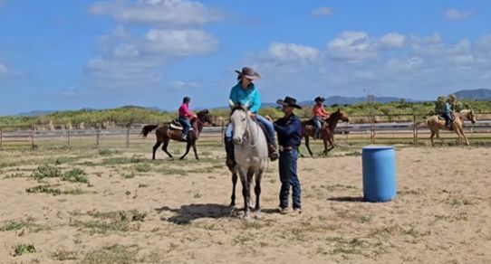 A Group Of People Are Riding Horses In A Field — Jono Battle Equine Services In Hunter Region, NSW