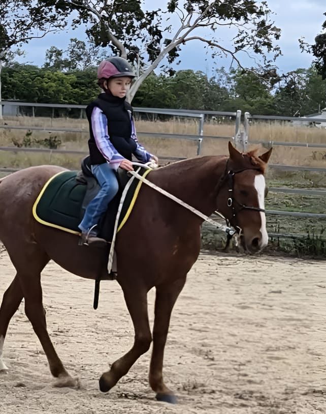 A Young Boy Is Riding A Brown Horse In A Dirt Field — Jono Battle Equine Services In Hunter Region, NSW