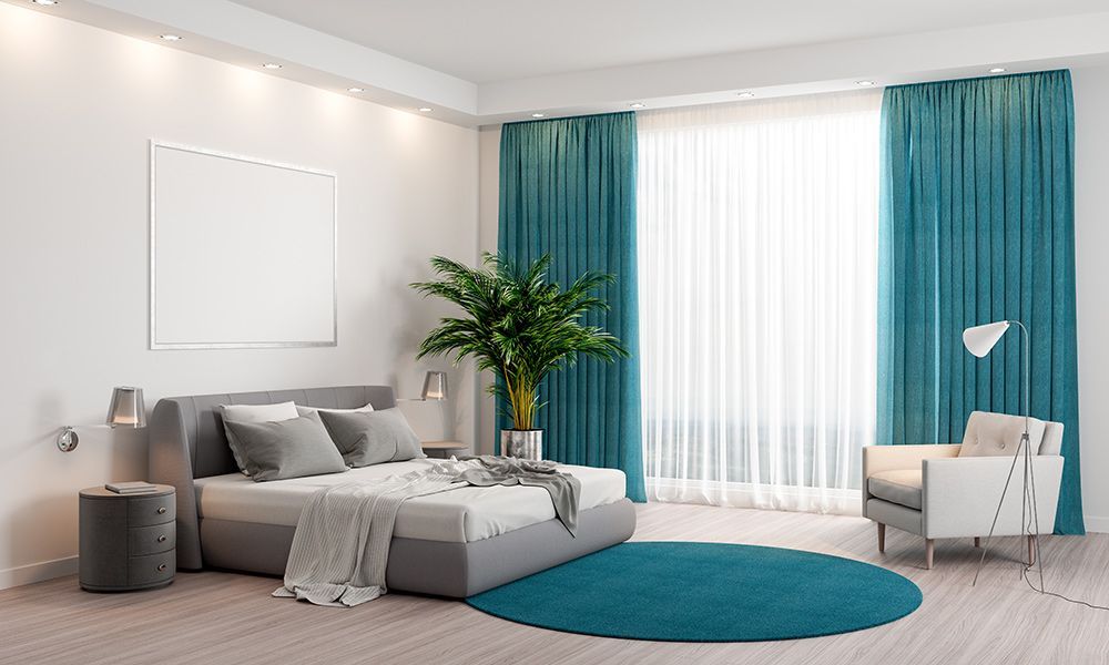 Modern Bedroom Interior with Elegant Blue Curtains — Southern Blinds & Awnings In Moss Vale NSW