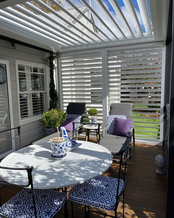 Outdoor Scene with Table, Chairs, and White Window Shutter — Southern Blinds & Awnings In Wilton NSW