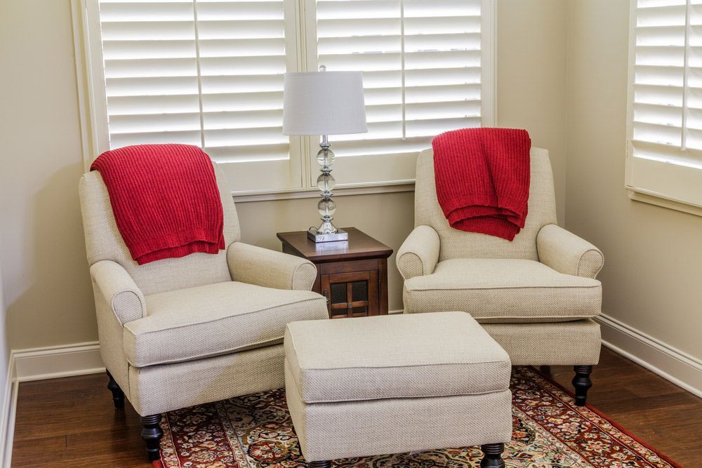 White Chairs with Red Throws in Sunlit Room — Southern Blinds & Awnings In Bundanoon NSW
