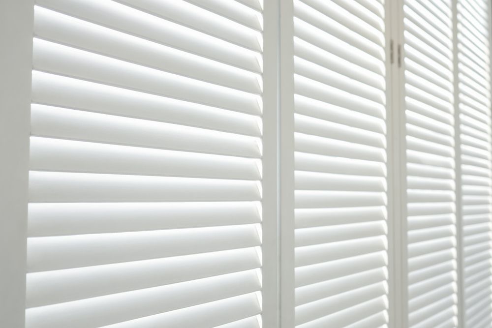White Wooden Shutters Adorning a Window — Southern Blinds & Awnings In Picton NSW