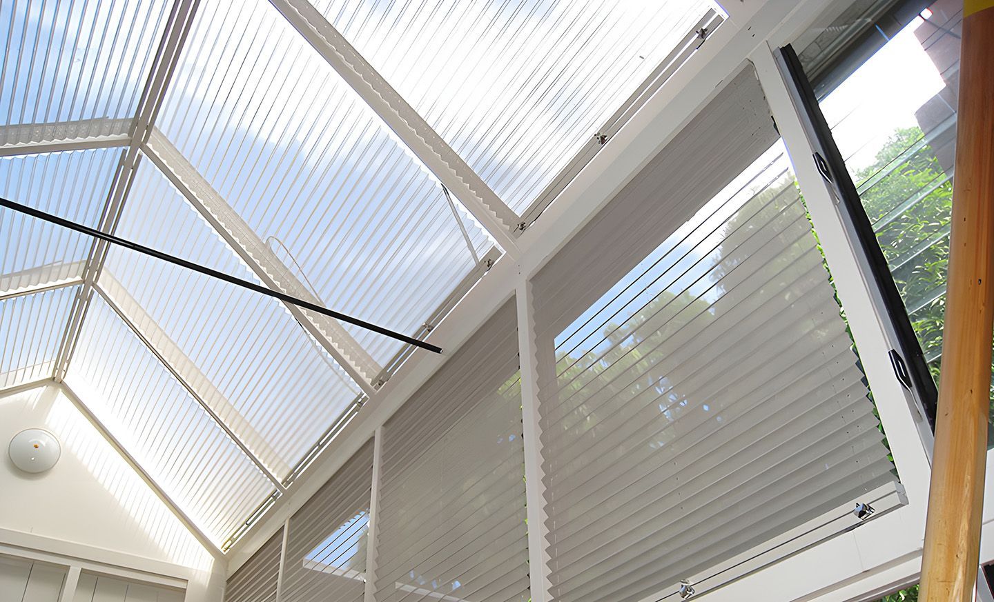 White Indoor Window Blinds Under Translucent Roof Panels