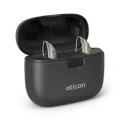 Two beige Oticon hearing aids in a black charging case.