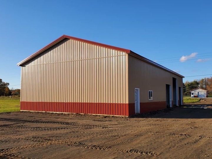 A tan and red building with a red roof