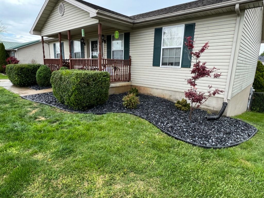 A mobile home with a large lawn in front of it.