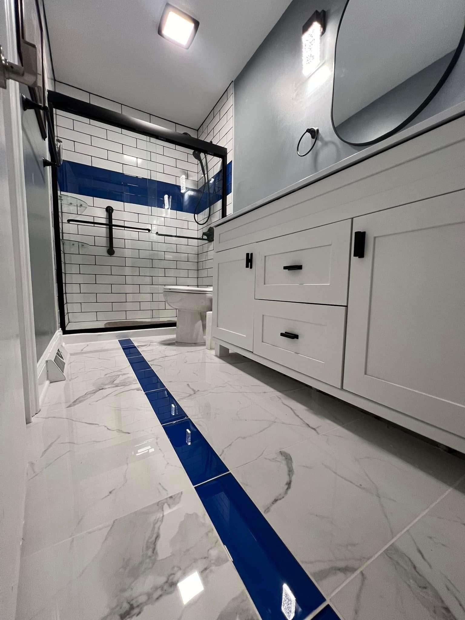 A bathroom with a toilet , sink and mirror