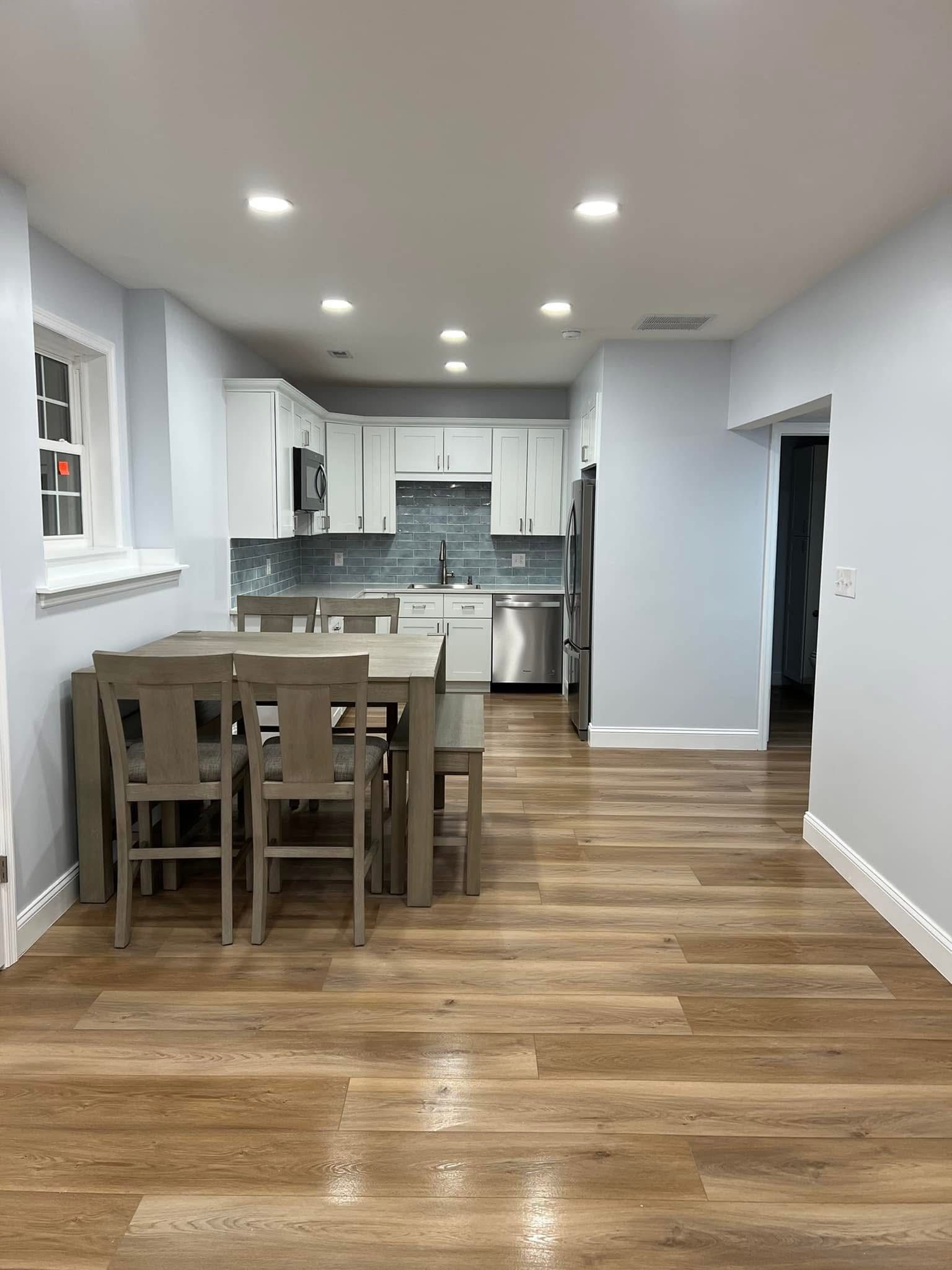 A kitchen with a table and chairs in it