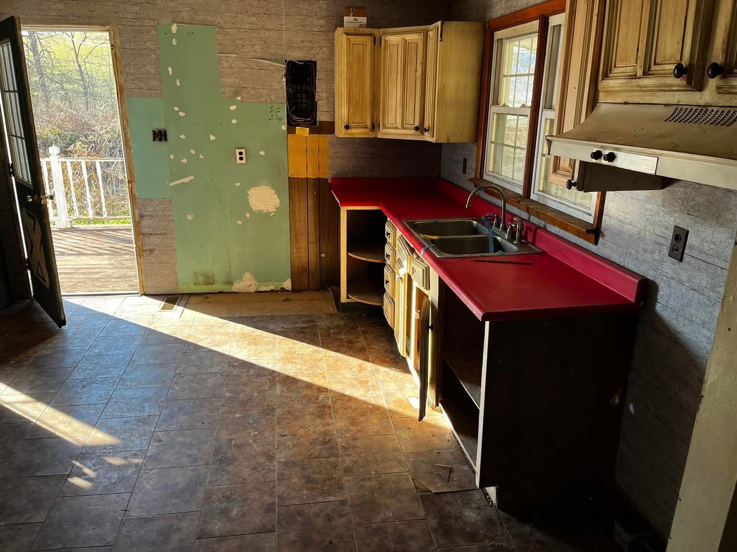 A kitchen with a red counter top and a sink