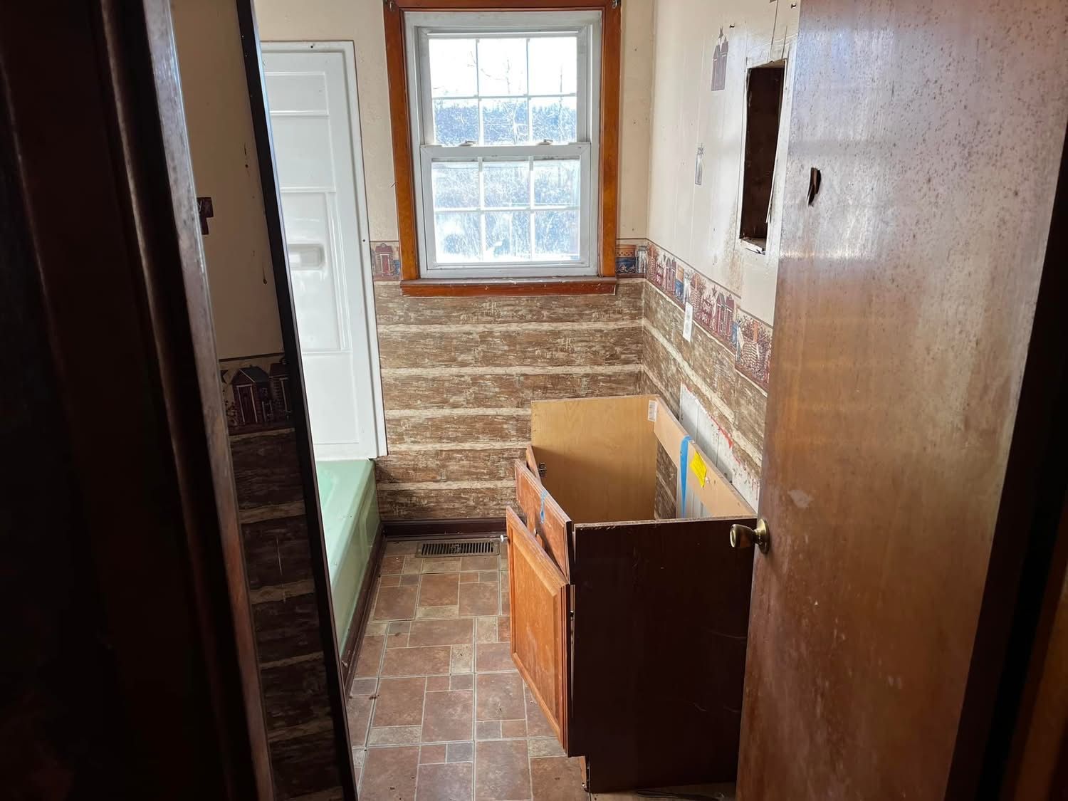 A bathroom with a sink and a window is being remodeled.
