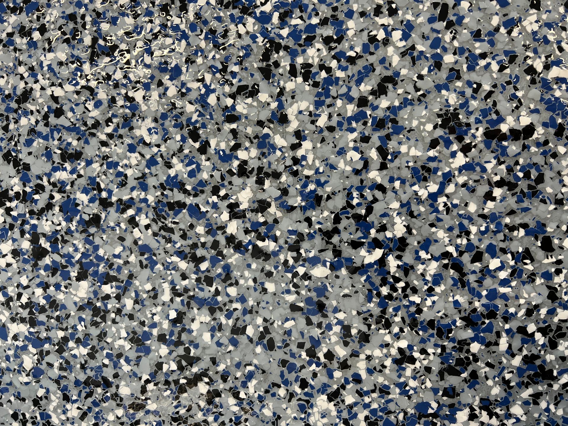A close up of a gray , black , and white marble texture.