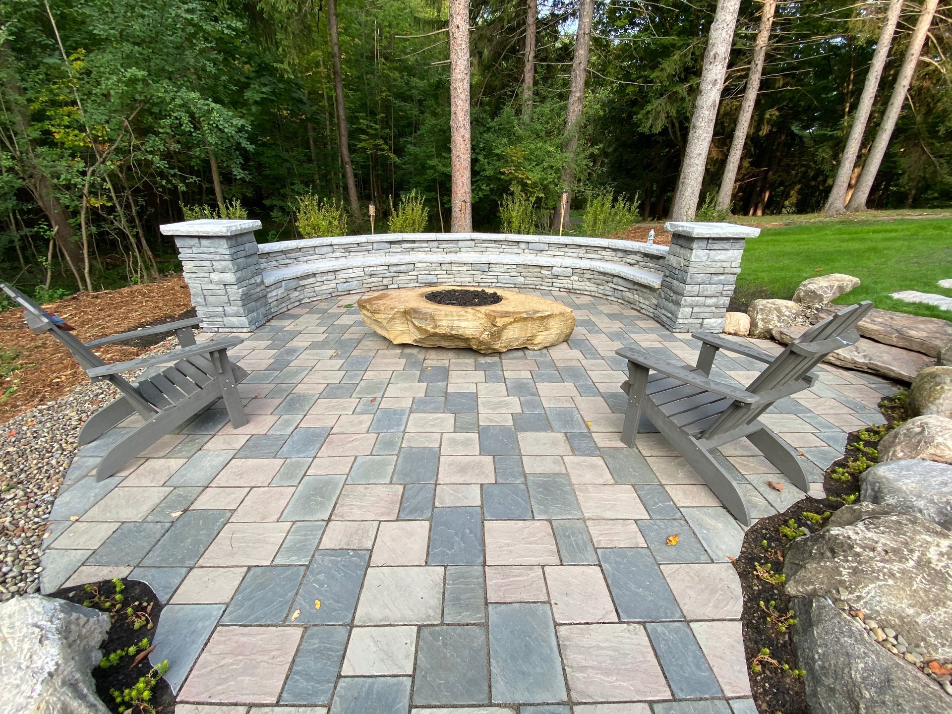 There is a fire pit in the middle of the patio.
