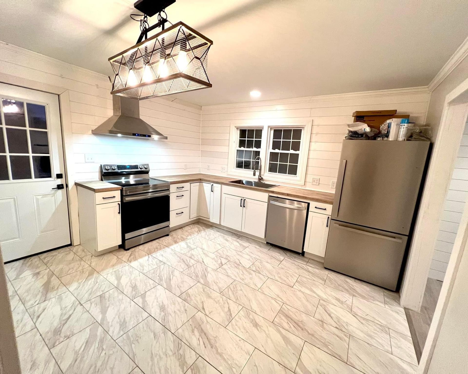 A kitchen with stainless steel appliances and white cabinets