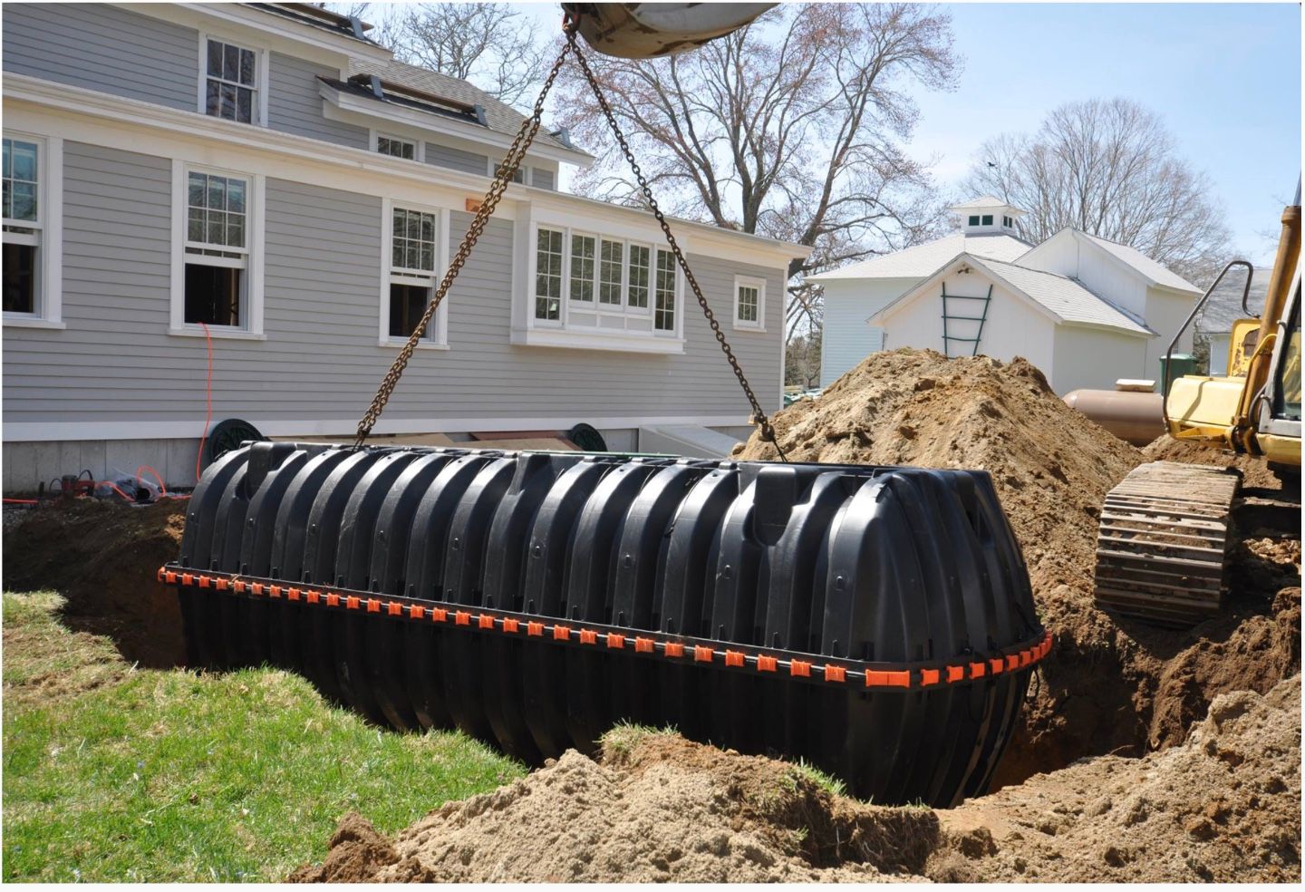 A plastic Septic tank being lowered into place.