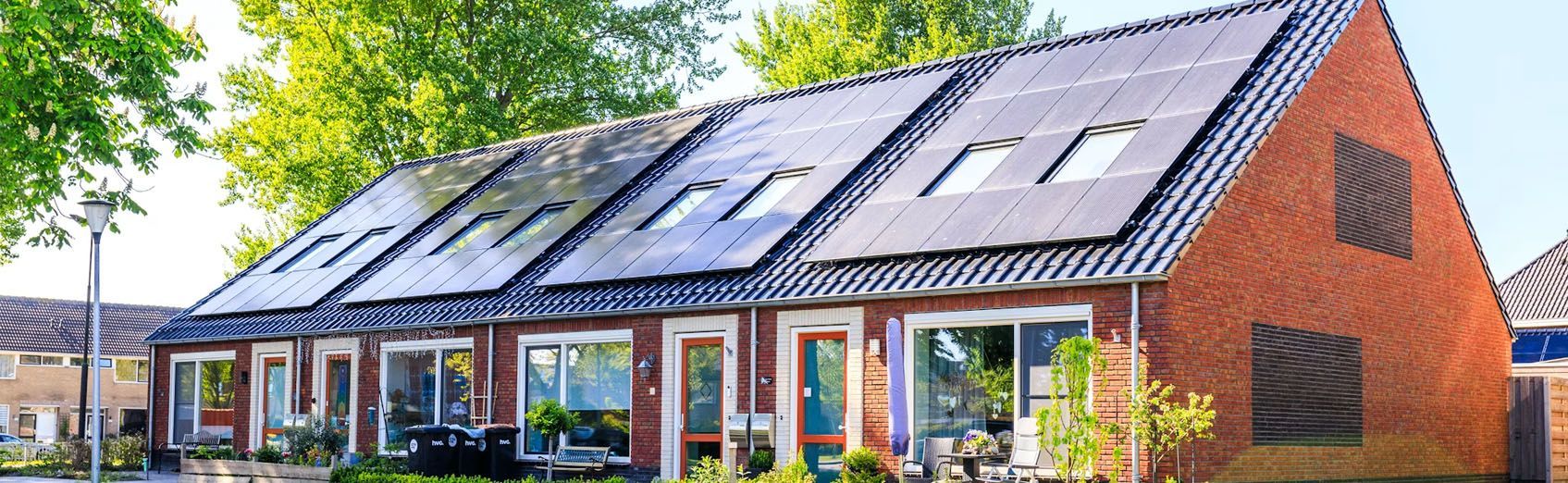 Modern brick building with solar panels on the roof and large windows along the front entrance
