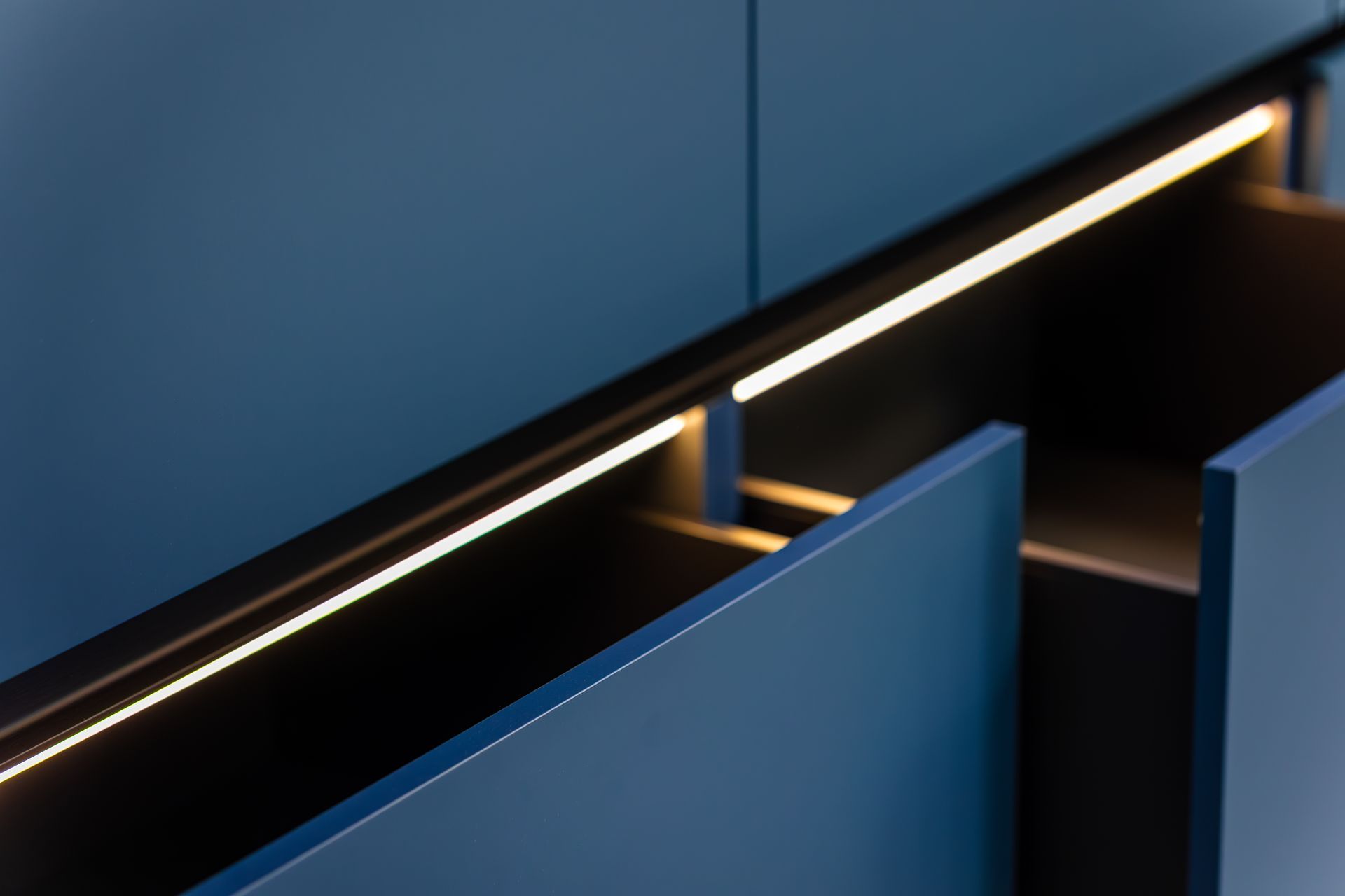 Blue geometric panels with diagonal black trim and warm orange lighting accents