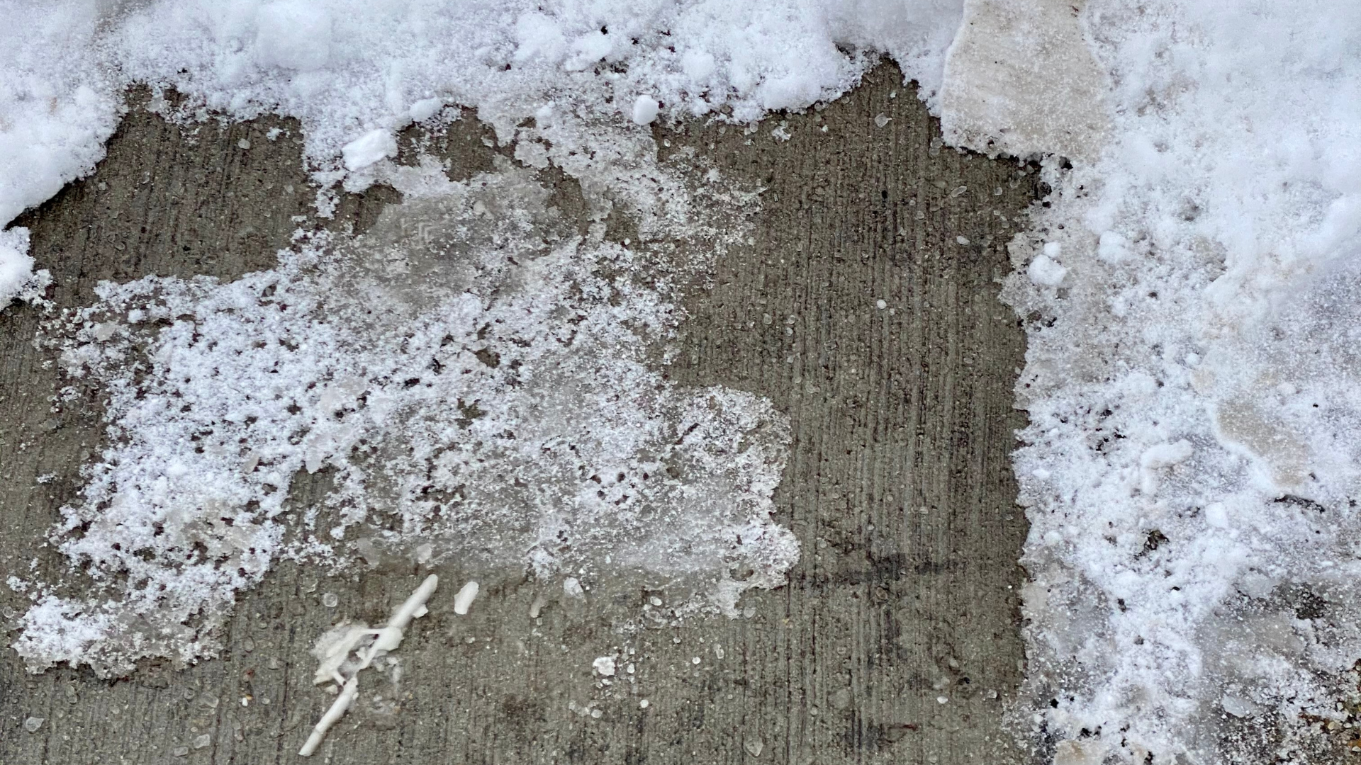 snow melting on concrete due to freeze-thaw cycle