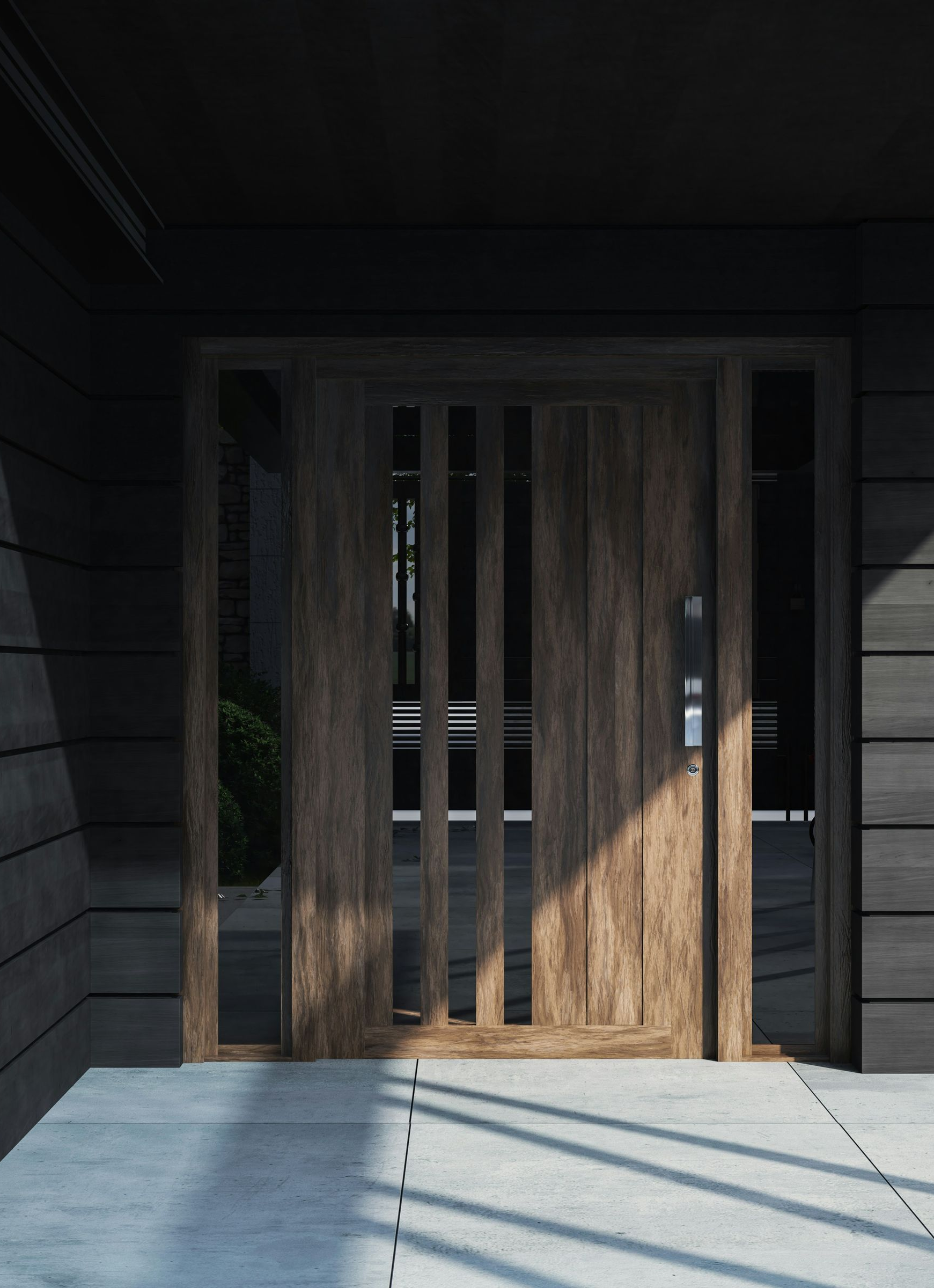 Wooden front door with vertical slats, set in a dark-paneled wall, casting shadows on the concrete porch.